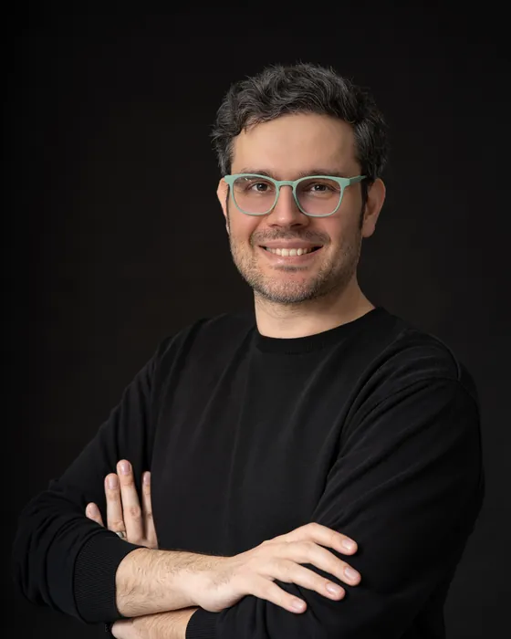 Hakan Şık, kollarını kavuşturmuş gülümsüyor